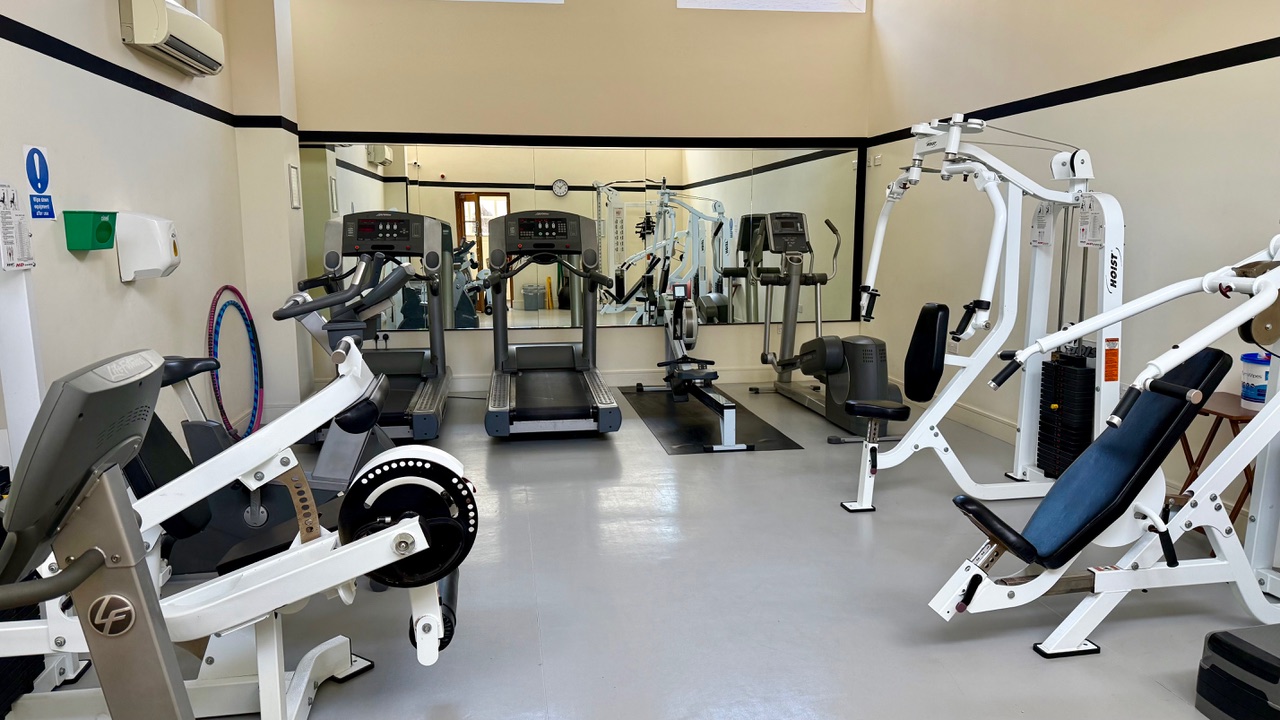 Hayes Point residents’ gym with treadmills, rowing machine, and weight station.